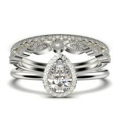 a pear shaped diamond ring set on top of each other with two matching wedding bands