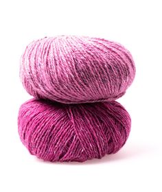 two skeins of pink yarn are stacked on top of each other