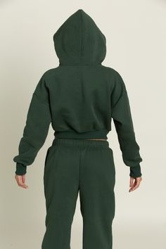 Upgrade your closet with our trendy and thoughtfully designed Hunter Green GH Cropped Hoodie. Hold your everyday necessities or keep your hands warm with the dual side pockets. Use the hood to change your look to match any occasion. Pair with our Hunter Green GH Jogger Sweatpants to complete the set. Loungewear Hoodie With Funnel Neck And Kangaroo Pocket, Green Drawstring Hood Sweatshirt For Loungewear, Hooded Hoodie With Ribbed Cuffs For Loungewear, Comfy Hoodie Sweatshirt With Drawstring Hood, Comfy Cotton Hoodie With Adjustable Hood, Fleece Hoodie With Funnel Neck For Loungewear, Comfy Cotton Hooded Hoodie, Comfortable Green Hoodie For Fall, Adjustable Hood Hoodie For Loungewear