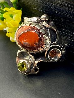 Artisan Mexican Fire Opal Gemstone ring in sterling silver  Hand-made Sterling Silver 925, size 9 1/2 Stones used: Mexican Fire Opal, Peridot, Citrine, Iolite Face of the ring:  Height-30mm, Width-18mm, Band-10-5mm Unique Handcrafted One-of a-kind Design Ring Each Piece of Jewelry in my Collection is Absolutely One of a Kind! When you start wearing a piece of my jewelry you will fall in love with it more and more each day and feel that good Energy and Love that I pass into it while creating this Orange Fire Opal Ring, Sterling Silver Orange Gemstone Rings, Southwestern Red Multi-stone Ring, Mexican Fire Opal Jewelry, Ring Unique Design, Mexican Fire Opal Necklace, Mexican Fire Opal, Gift For Woman, Handcrafted Rings