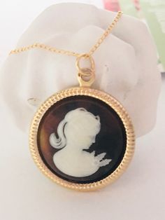 "Coffee Cameo Necklace, Gold Filled Cameo Necklace, Victorian Necklace, Cameo Pendant, Cameo jewelry, Cameo Pearl Necklace, Romantic Gift ♡ Ivory White on Coffee background Lady Cameo  ♡ Set in a Gold plated 25mm (1\") round frame ♡ Dainty 14k Gold filled chain, 18\" with spring ring clasp  ♡ Crafting materials are from the USA  ♡ Handcrafted with Love & Care in Redondo Beach, CA ♡ Your purchase will arrive in a gift bag or box. ♡ Invoices are not included in packages. ♥ Thank you! ~ Penelope's Cameo Jewelry Gift, Cameo Jewelry Gift Round Shape, Cameo Round Jewelry Gift, Cameo Medallion Jewelry Gift, Cameo Medallion Jewelry For Gifts, Cameo Round Pendant Necklace For Wedding, Wedding Necklaces With Cameo Round Pendant, Victorian Necklace For Gift, Antique Cameo Necklace With Round Pendant