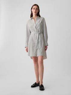 Soft poplin cotton mini shirtdress.  Point collar.  Long sleeves with button cuffs.  Button front.  Patch pocket at chest.  Tie belt at waist.  Allover stripes.  Made with 100% organically grown cotton, which is better for people and the environment because it's grown without the use of harmful synthetic pesticides and fertilizers.  * Fit: Classic.  A shift silhouette with a straight & easy fit.  Hits above the knee.  Models wearing Gap Striped Button-up Shirt Dress For Vacation, Striped Button-up Dress With Relaxed Fit, Striped Short-sleeved Shirt Dress For Vacation, Striped Relaxed Fit Button-up Shirt Dress, Casual Striped Shirt Dress, Affordable, Which Is Better, Pesticides, Shirtdress, Tie Belt