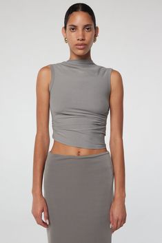 Effortlessly draped and versatile, the Selma tank is a must-have. With ruched detailing and a high neck, it's perfect for any occasion. Fitted Sleeveless Tank Top With Ruched Back, Sleeveless Stretch Tops With Ruched Back, Chic Stretch Tank Top With Ruched Back, Summer Tops With Ruched Sides And Elastane, Elastane Tank Top For Night Out, Sleeveless Elastane Top With Ruched Back, Sleeveless Ruched Back Top, Versatile Stretch Ruched Tank Top, Ruched Tank Top For Night Out