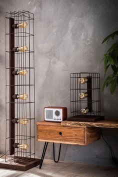 a wooden table topped with a radio next to a metal rack