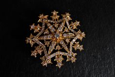 Vintage Straits Chinese pendant brooch set with diamonds in 18k. The diamonds are white and fiery. Refined from Victorian brooches, this star-in-a-flower motif is an East West style Straits Chinese brooches are known for. This piece is considered ornate, the pierced work is a distinct star theme with an elongated star-flower centre. This piece could be older, since it has Chinese hallmarks, seen on the pendant bail hidden at the back. The piece is at the fancier wing of Anglophilia, its Victoria Elegant Star-shaped Brooch Jewelry, Elegant Star-shaped Jewelry Brooch, Elegant Star-shaped Brooch, Formal Star-shaped Brooch Jewelry, Elegant Star-shaped Brooch For Gift, Elegant Star-shaped Brooches For Gifts, Elegant Star Shaped Brooches For Gift, Elegant Star-shaped Wedding Brooch, 7 Pointed Star