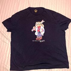 Ralph Lauren Ski Teddy Bear T-Shirt. This Graphic Tee Features Ralph Lauren's Iconic Mascot Dressed For A Day On The Slopes. Straight Fit. Intended To Hit At The Hip. Crewneck. Short Sleeves. 100% Cotton. Color Dark Navy Blue Size 2xlt Women's Brand New Item No Tags Flawless Condition. Comes From A Clean Non-Smoking Home. Polo Ralph Lauren Women, Bear Shirt, Bear T Shirt, Dark Navy Blue, Ralph Lauren Tops, Ralph Lauren Womens, Christmas Wishlist, Dark Navy, Women Brands