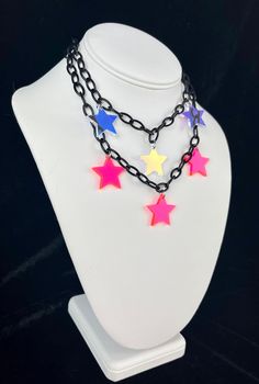 FREE Shipping on orders $35 and up! Star Girl Choker The Star Girl choker is made with high-quality lightweight material, perfect for raves and festivals! The iridescent star charms shine and reflect prisms of light under the sun. - Charms are made with lightweight iridescent acrylic- color appearance changes depending on lighting - Adjustable from 14 to 16 inches (message me for length customizations up to 20-22inches) Matching earrings here!- https://www.etsy.com/listing/1380601428/star-irides Adjustable Rave Choker For Festival, Adjustable Multicolor Rave Choker, Trendy Rainbow Necklace For Festivals, Adjustable Rave Style Choker, Trendy Multicolor Star Necklace, Trendy Multicolor Star Shaped Necklace, Rainbow Adjustable Choker For Festival, Rainbow Adjustable Choker For Festivals, Multicolor Rave Jewelry For Festival