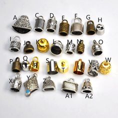 many different types and sizes of rings on a white surface with letters in the background