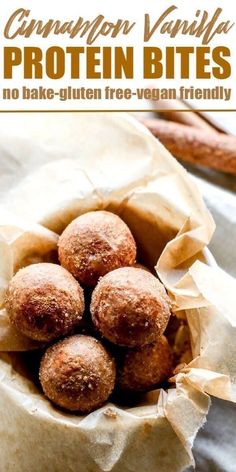 four vegan protein bites in a bowl with parchment paper and cinnamon stick on the side