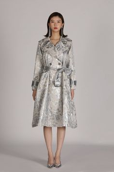 Silver Flora trench coat is uniquely crafted with adjustable straps on waist and cuffs, which ensures the tailored fit and perfect level of snugness and comfort. This coat excels in durability and wind resistance. Material: Cotton, Nylon Silver Trench Coat, Elegant Long Raincoat For Fall, Elegant Long Fall Raincoat, Winter Long Fitted Raincoat, Elegant Winter Raincoat With Long Sleeves, Elegant Long Sleeve Winter Raincoat, Elegant Fall Raincoat, Elegant Long Winter Raincoat, Belted Long Raincoat For Spring