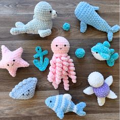 knitted sea animals are arranged on a wooden surface