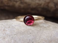 Garnet Gold Ring, Red Gemstone Stacking Ring, Dark Red Minimalist Ring, January Birthstone, Gold Filled Ring, Garnet jewelry, Red Stone Ring This red garnet gold stacking ring will be a perfect gift for women. It is made of 14k gold filled and garnet stone. Measurements: Size- all The center stone is 6 mm The ring will be packed in a gift box. FOR MY RINGS COLLECTION HERE: https://www.etsy.com/il-en/shop/rebekajewelry?section_id=14282915&ref=shopsection_leftnav_9 TO GET TO MY SHOP: https://w Dainty Red Round Jewelry, Red Round Stone Promise Ring, 14k Gold Red Cabochon Ruby Ring, Red Solitaire Round Cut Jewelry, Red Garnet Round Band Jewelry, Red Round Solitaire Jewelry, Red Garnet Round Cut Jewelry, Red Ruby Birthstone Ring With Round Stone, Red Round Cut Garnet Jewelry