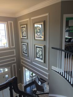 a staircase with framed pictures on the wall