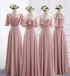 three bridesmaids in pink dresses standing next to each other with flower crowns on their heads