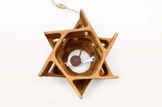 an ornament made out of wood with a light bulb in the shape of a star