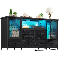 a black cabinet with blue glass doors and drawers on wheels is next to a lamp