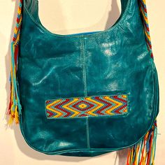 Nwot- This Unique Bag Is Made If High Quality Leather. Hand Woven Accents/ Strap Yellow, Red, Blue& Orange. Adjustable Strap. Zips Closed. 3 Interior And 1 Back Pocket. Purchased During Travels, Ended Up Getting A Different One, Never Used. Turquoise Leather Shopping Bag, Blue Leather Hobo Bag, Turquoise Leather Everyday Shoulder Bag, Blue Bohemian Satchel Hobo Bag, Bohemian Blue Hobo Satchel Bag, Green Leather Hobo Bag Casual Style, Blue Bohemian Hobo Bag, Blue Bohemian Leather Bag, Bohemian Blue Leather Bag