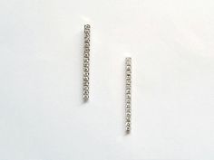 18k gold Line diamonds Bar Delicate studs earrings set with 16 diamonds on each earring. Simple and elegant diamonds stud earrings. Designed as a narrow long gold bar set with beautiful white diamonds. Fits special events and ultimate pick for a bride. It is comfortable to wear. - Ready To ship - Those 18k white gold earrings are ready to be shipped in 1-4 business days. - DETAILS - Metal: 18k white solid gold Gold Line Length: app. 18mm Gold Line Thickness: app. 1.3mm Diamond parameters: Clarit Modern Wedding Earrings With Single Cut Diamonds, Modern Formal Diamond Earrings With Single Cut Diamonds, Diamond White Channel Set Diamond Earrings As Gift, Modern Single Cut Diamond Earrings For Formal Events, Minimalist Formal Diamond Drop Earrings, Luxury Linear Earrings With Single Cut Diamonds For Anniversary, Modern White Diamond Earrings With Single Cut Diamonds, Modern Single Cut Diamond Earrings For Wedding, Diamond White Diamond Earrings With Channel Set