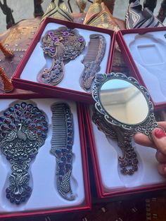 a person is holding several different types of hair combs