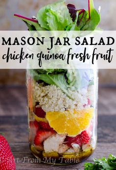 mason jar salad with chicken, quinoa freshfruit and strawberries in it