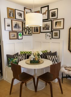 the dining room table and chairs are all white with brown trimmings on them