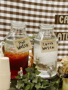 there are two jars with liquid in them on the table next to other items and decorations