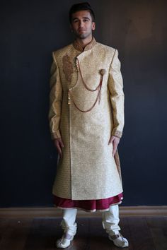 The Gold and Maroon Sherwani is beautifully designed on a satin/silk material embroidered in gold. Comes with a Gold Pajama and Maroon kurta. Can be altered to size for an additional cost. Measurements are listed as below: Sherwani Length: 44 inches  Sleeve Length:  26 inches Chest Length:  42 inches Kurta Length: 46 inches Kurta Chest: 21 inches Pant: 46 inches Pant Waist: 42 inches Semi-stitched Silk Sherwani For Designer Wear, Designer Semi-stitched Silk Sherwani, Wedding Semi-stitched Silk Sherwani, Gold Designer Kurta For Transitional Season, Gold Designer Kurta For Festivals, Gold Raw Silk Salwar Kameez With Straight Kurta, Semi-stitched Gold Kurta For Festive Occasions, Designer Silk Sherwani With Traditional Drape, Silk Sherwani With Zari Work For Wedding