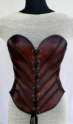 It is handmade leather corset with hand-sewn leather detailing. Fully adjustable at front with lace and back side with buckles. We used about 2 to 2.2 mm thick handmade leather. It is hand dyed handmade leather. It is crazy for medieval events and Larp.   Corset is hand made from sturdy top-grain leather.  Size is available from 30 to 36 inch, please check our size chart. bust size is in Size-chart.  DETAILS: ► 100% Handmade ► 100% Genuine leather ► Made on your measurements ► Unique design ► LA Luxury Leather Party Corset, Luxury Elegant Leather Corset, Luxury Fitted Medieval Style Corset, Luxury Medieval Corset With Historical Design, Leather Products Ideas Handmade, Httyd Clothes, Leather Armor Women, Brown Leather Corset, Leather Accessories Diy