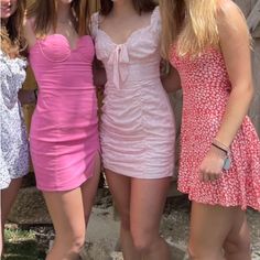 three women in dresses posing for the camera