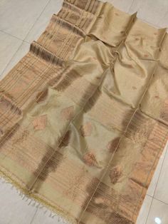 Primium quality Tussur Jamdani Saree,a masterpiece of the artwork from the Bengal weavers. Original tussur color ,deep cream color shade with wide copper zari  weaving border.Jamdani zari weaved Pallu ends with cotton tussels. Saree will give you authentic traditional bengali look in Durga puja ,festival or weeding. Light weight comfortable saree. Comes with running blouse piece. Silk mark certified product. We can assure with best quality authentic and genuin product. Please note thread pull an Gold Tussar Silk Traditional Wear With Cutdana, Gold Slub Silk Traditional Wear With Dupatta, Gold Slub Silk Dupatta For Transitional Season, Transitional Gold Slub Silk Dupatta, Unstitched Gold Tussar Silk Traditional Wear, Gold Tussar Silk Dupatta With Zari Work, Gold Traditional Wear With Zari Work In Slub Silk, Gold Tussar Silk Traditional Wear With Self Design, Gold Tussar Silk Saree For Transitional Season