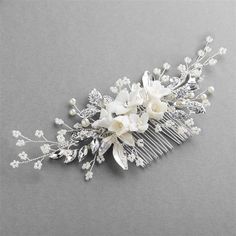 Silver Floral Bridal Comb Matte white resin flowers, crystals, dainty pearl sprays and delicate seed beads make this silver plated bridal comb a must-have hair accessory for your wedding. This handcrafted wedding comb is a work of art and the flexible sprays can be easily sculpted for the perfect look for your bridal hairstyle. Size: 6" wide and 2 1/2" high on a 1 ¾" wide flexible metal comb. Color: Silver/White. Style: 4607HCS. Please allow about a week for delivery. Shipping Policy . Return Po Vine Hair Piece, Rustic Wedding Veil, Floral Bridal Hair Accessories, Floral Bridal Comb, Floral Wedding Hair, Wedding Comb, Perfect Hairstyle, Boho Bouquet, Flower Comb