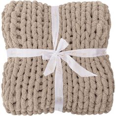 two beige knitted blankets wrapped in white ribbon and tied with a bow on top