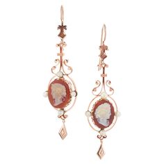 Pendant dangle style 1900’s 15k rose gold carved hardstone cameo dangle earrings with natural pearl accents, one or two may have been replaced with cultured pearls. 2 crème orange brown hardstone cameos 8 gray crème pearls, 3.4mm 15k rose gold 15k yellow gold Tested: 15k 14.7 grams Top to bottom: 65mm or 2.5 Inches Width: 19.9mm or .75 Inch Depth or thickness: 20.0mm Victorian Wedding Ring, Antique Wedding Bands, Rose Gold Dangle Earrings, Diamond Sapphire Engagement Ring, Antique Engagement Rings Vintage, Antique Bracelets, Vintage Sapphire, Victorian Wedding, Gold Dangle Earrings