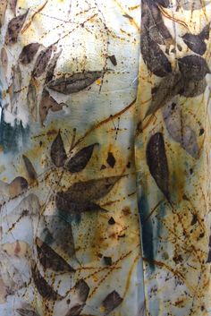 an image of the back of a dress with leaves on it and rusted paint