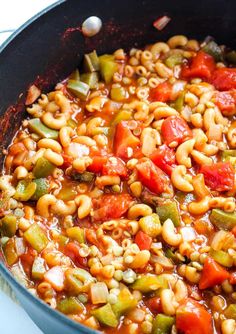 a pot filled with beans and vegetables on top of a stove