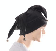 Three pointed jester hat made in black fleece. This is a joker style fools cap, one point in the front with two points to the rear side. Each of the point are tipped off with a silver jingle bell. Black double thick headband. One size fits most adults 22-24 inch heads. MG001630 Novelty Black Costume Accessories For Winter, Black Novelty Costume Accessories For Winter, Adjustable Black Costume Accessories For Winter, Black Adjustable Costume Accessories, Joker Halloween Costume, Halloween Costume Hats, Thick Headband, Joker Halloween, Thick Headbands