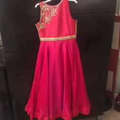 Indian Girls Silk Gown. Never Worn Festive Sleeveless Princess Dress For Wedding, Sleeveless Princess Dress For Wedding And Festive Occasions, Festive Sleeveless Wedding Princess Dress, Red Sleeveless Princess Gown, Red Floor-length Dress For Fancy Dress Occasion, Red Floor-length Fancy Dress, Pink Sleeveless Gown For Fancy Dress, Red Fitted Gown For Dress-up, Fitted Pink Princess Dress For Festive Occasions