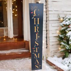 a christmas sign in front of a house