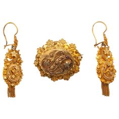 This is an antique early 20th century jewelry set consisting of earrings and a brooch. The gold has beautiful cannetille work set with wire work knots and stars. In the Netherlands, these knots are also-called 'spiders', the body in the center surrounded by its legs. These jewels show an abundant scene of fine cannetille work. The earrings and brooch have a lovely decoration and the borders have scalloped edges. The spiral wire work on the earrings are also know as cornucopia, which means abundance. Underneath the earrings dangling tassels are hung. This kind of jewelry was worn by women around 1900 in the southern part of The Netherlands, in Brabant. The set is in good condition. Marked and tested as 14k gold. The back of the brooch has a base metal pin and has some small solder spots. Br Gold Tassel Earrings, Gold Jewelry Sets, Yellow Gold Jewelry, Brooch Jewelry, Gold Filigree, Metal Pins, Wire Work, Tassel Earrings, Base Metal