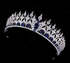 Sapphire Blue Royal Replica Tiara and Earrings You'll fall in love with this stunning tiara with coordinating sapphire blue earrings. This regal tiara is a replica of the 1881 Dutch Sapphire royal tiara, with a smaller height to appeal to today's modern bride. This fabulous headpiece features a lavish platinum plated design decorated with brilliant clear and sapphire blue AAAAA quality cubic zirconia crystals. The stunning tiara will have you feeling like royalty on your special day. The coordin Sapphire Blue Earrings, Rhaenys Targaryen, Winter Wedding Accessories, Royalty Crown, Crystal Headpiece Wedding, Crystal Wedding Tiaras, Crystal Crown Wedding, Crystal Bridal Tiaras, Royal Crowns