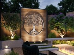 an outdoor patio with fire pit, benches and trees on the wall at night time