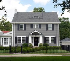 a gray house with white trim and black shutters