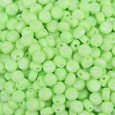 neon green beads with white letters on them