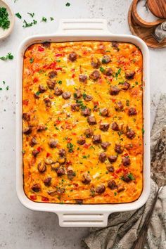 a casserole dish with meatballs and cheese