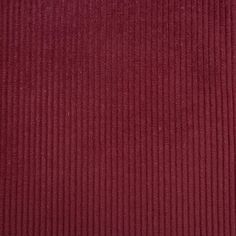 a close up view of a red corded fabric textured with dark brown pinstripe