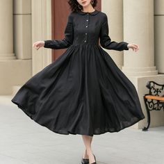 "Revamp your wardrobe with this chic black dress, perfect for the spring season! It's all about the details, with its eye-catching button design, this black dress never goes out of style. It's a staple spring fashion piece that adds an elegant twist to your look, making it ideal for both casual and formal occasions.  DETAIL * 100% linen fabric * Collared neck * Two side pockets * Right side zipper * Length below the knee * Long sleeve dress * Button up dress * Midi dress * Swing dress * Black Dr Black A-line Shirt Dress, Black Linen Dresses For Fall, Chic Long Sleeve Linen Dress With Buttons, Black A-line Vintage Dress For Spring, Black Vintage Dress For Spring, Casual Black A-line Shirt Dress, Black Linen Long Sleeve Dress For Spring, Spring Black Collared Midi Dress, Black Collared Midi Dress For Spring