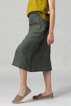 READY TO SHIP - Minimalist seasonless A-line linen skirt featuring an elasticated back waist for increased comfort and flattering fit and midi length which makes it easy to style with any top shape.  Made of pure washed European linen for a perfectly soft feel and naturally wrinkled look.  FIT The A-Line Skirt has a relaxed fit and sits slightly below the waistline. The intended positive ease around the hips is 8-12 cm/3.1-4.7".  To choose the right size, check out our body and garments measurem Versatile Solid Color Midi Skirt, Versatile Solid Color Pencil Skirt, Versatile Knee-length Flowy Skirt, Spring Maxi Skirt In Solid Color, Versatile Lined Skirt, Plain Knee-length Skirt For Spring, Solid Versatile Knee-length Skirt, Relaxed Pencil Skirt In Solid Color, Green Relaxed Fit Knee-length Skirt