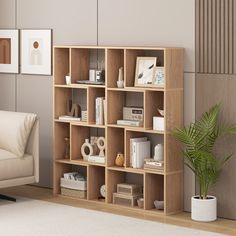 a living room filled with furniture and a book shelf next to a white couch in front of a wall