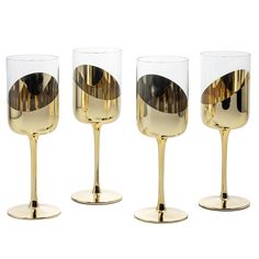 three wine glasses with gold rims are sitting side by side