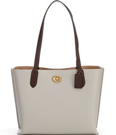 From COACH, the Willow Colorblock and Signature Interior Tote Bag features:Polished pebble leather and Signature coated canvasTurnlock and magnetic snap closuresCenter zip compartmentDouble handles Four protective feet at baseApprox. 13.5" L x 10.75" H x 5.75" W bag; 11.5" handle dropImported. Coach Coated Canvas Bags For Work, Rectangular Coated Canvas Bag With Magnetic Closure, White Rectangular Pebbled Leather Shoulder Bag, Cream Bags With Leather Trim For Work, Everyday Shoulder Bag With Magnetic Closure In Coated Canvas, Coach Bag With Magnetic Closure For Daily Use, Cream Leather Trim Bag For Work, Cream Workwear Bags With Leather Trim, White Pebbled Leather Bag With Gold-tone Hardware